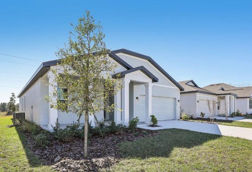 Front exterior of a new home in Sunbrooke, St. Cloud, FL, highlighting curb appeal (Image 2). Front exterior of a new home in Sunbrooke, St. Cloud, FL, highlighting curb appeal (Image 2).