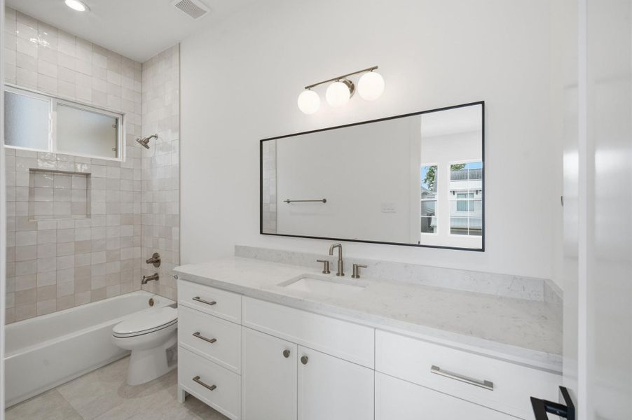 Bath 3 offers quartz countertops, shaker cabinets and a tub/shower combo.