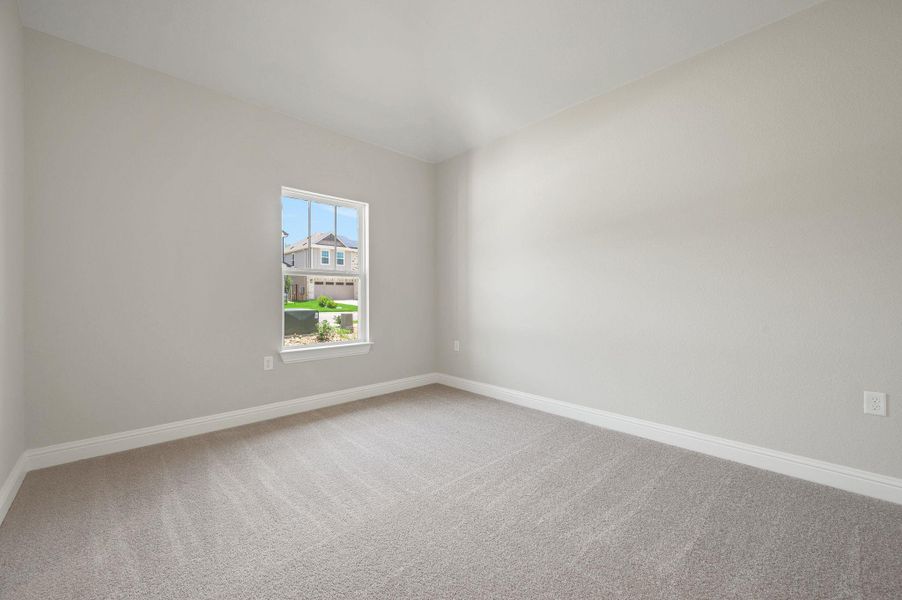 Carpeted empty room with baseboards Carpeted empty room with baseboards