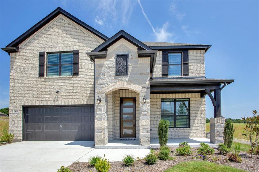 View of front of home featuring a garage