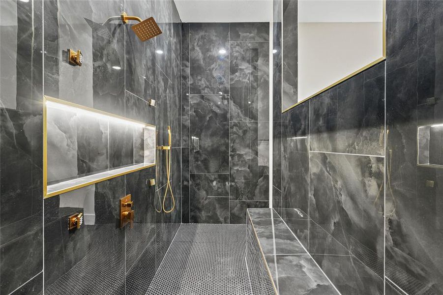 Full bath with a marble finish shower