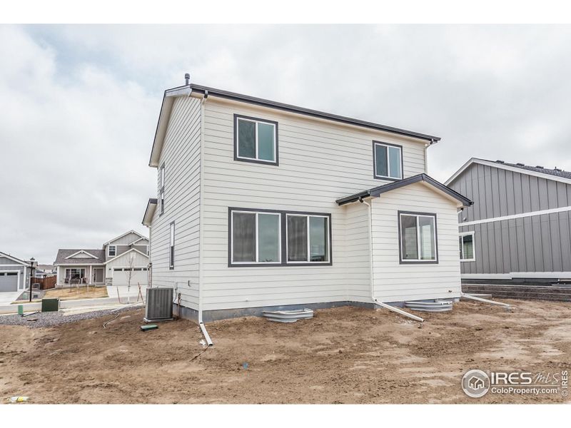 Front exterior of a new home in Promontory Point, Greeley, CO, highlighting curb appeal (Image 22). Front exterior of a new home in Promontory Point, Greeley, CO, highlighting curb appeal (Image 22).