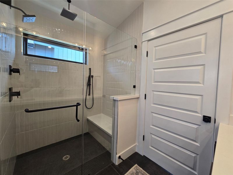 Many showering options in the large walk in shower - bench, overhead shower, rain shower, and a handheld.