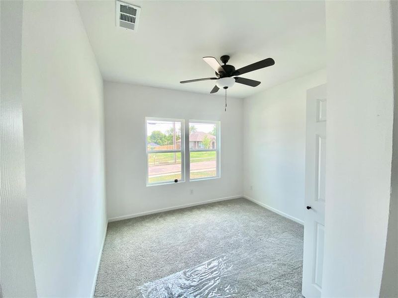 Spare room with light carpet and ceiling fan