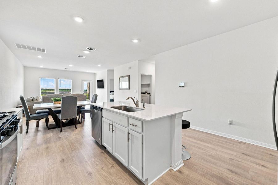 An open floorplan seamlessly connects the functional kitchen space to the adjoining dining area.
