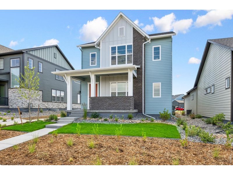 Front exterior of a new home in Kinston Cottage, Loveland, CO, highlighting curb appeal (Image 24). Front exterior of a new home in Kinston Cottage, Loveland, CO, highlighting curb appeal (Image 24).