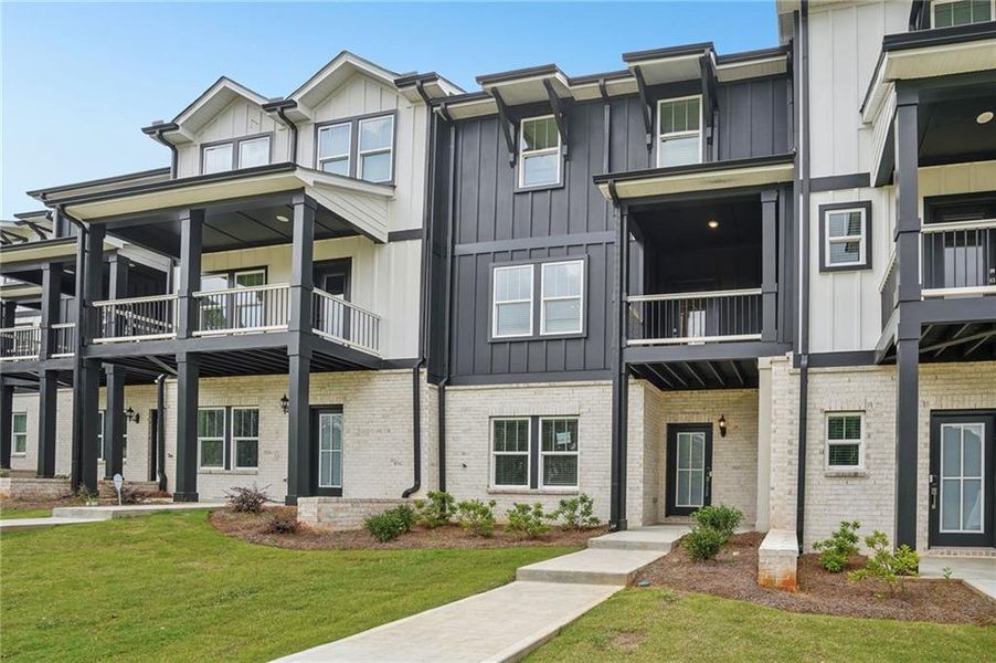 Front exterior of a new home in Hemingway - Highland Series, Cumming, GA, highlighting curb appeal (Image 2). Front exterior of a new home in Hemingway - Highland Series, Cumming, GA, highlighting curb appeal (Image 2).