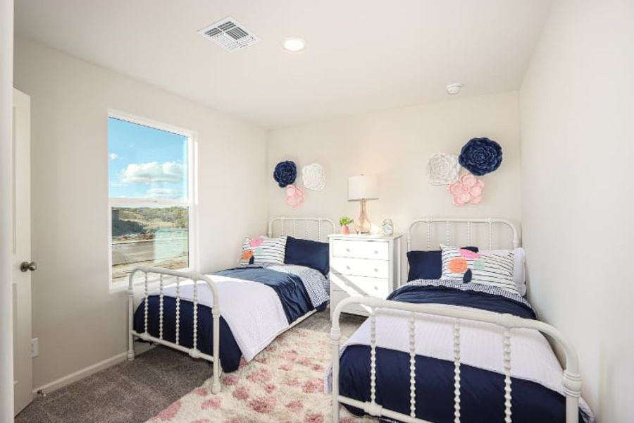 A bedroom with two beds.