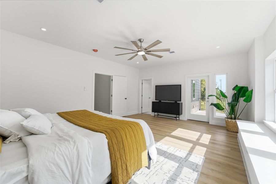 Light-filled and spacious primary suite, enhanced by large windows, wood-look flooring, and direct access to a private balcony. Light-filled and spacious primary suite, enhanced by large windows, wood-look flooring, and direct access to a private balcony.