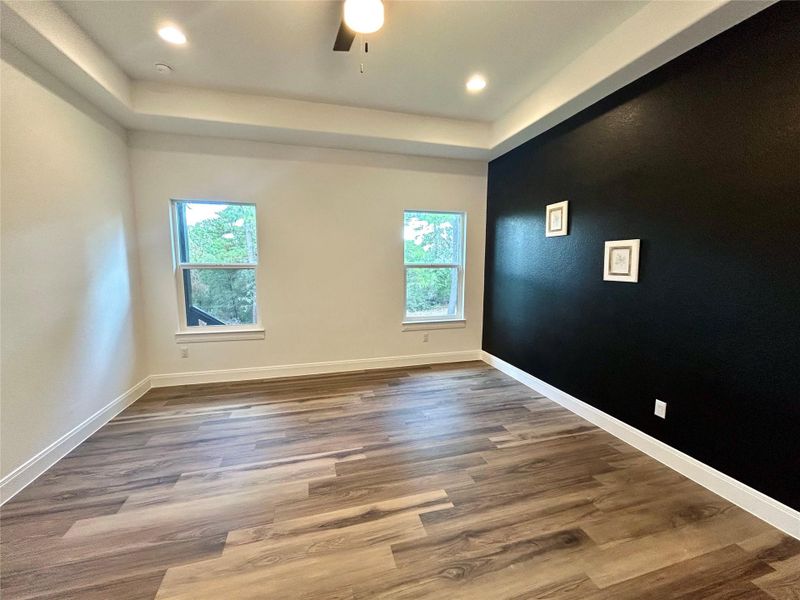 Primary bedroom with tray ceiling. Primary bedroom with tray ceiling.