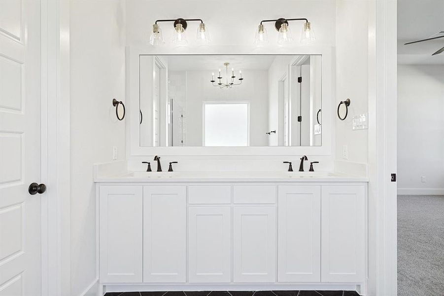 Primary Bathroom featuring vanity and ceiling fan with notable chandelier