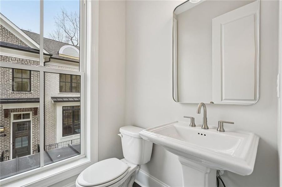 Powder Bathroom with pedestal sink has plenty of natural light