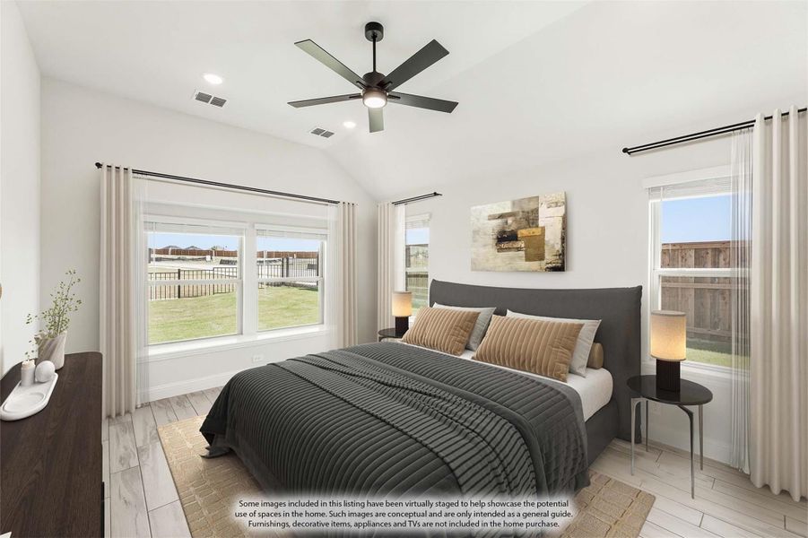 Bedroom with vaulted ceiling, ceiling fan, light wood floors, and large windows with backyard view