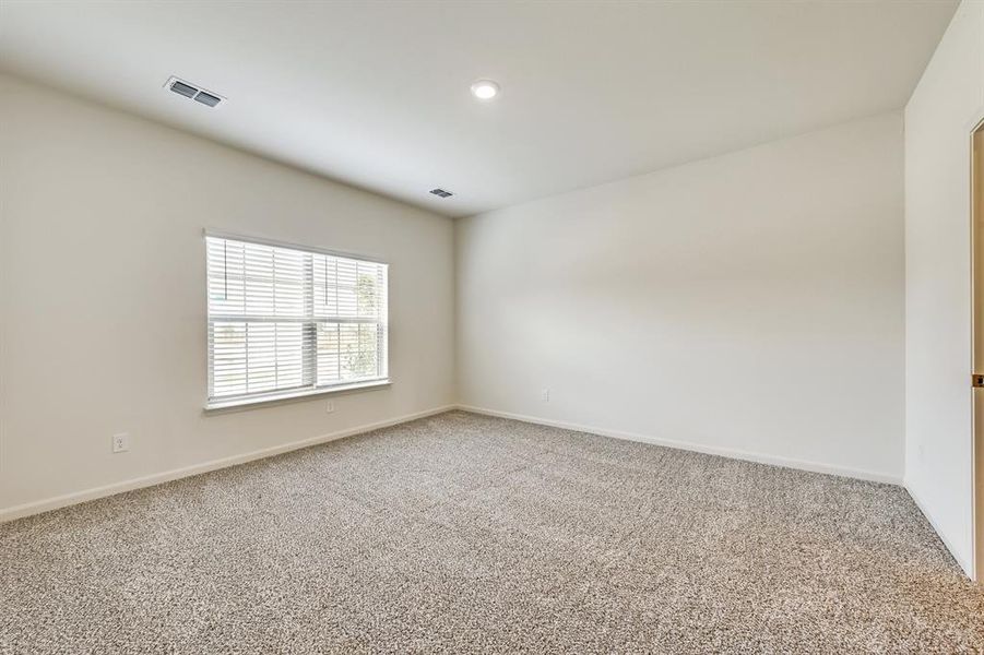 View of carpeted primary bedroom