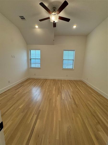 Empty room with plenty of natural light, light wood-style floors, and baseboards