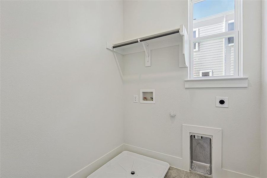 Laundry area with gas dryer hookup, hookup for a washing machine, and electric dryer hookup