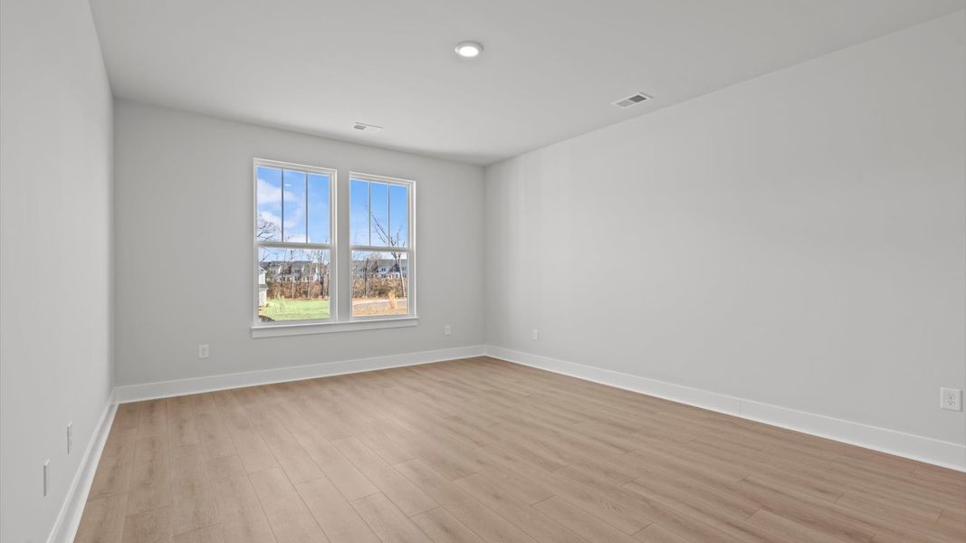 First-class hardwood floors and tasteful finishes elevate the private retreat of this exceptional primary suite