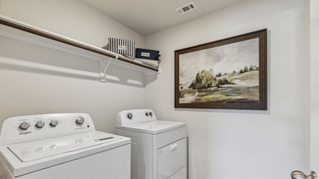 Laundry area featuring washing machine and clothes dryer