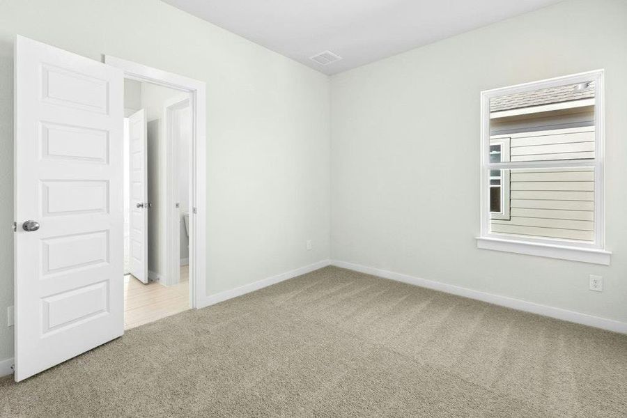 Carpeted spare room with baseboards