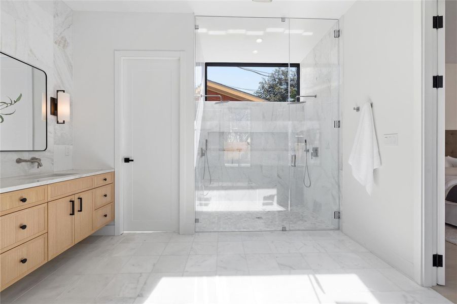 Ensuite bathroom with a marble finish shower and vanity