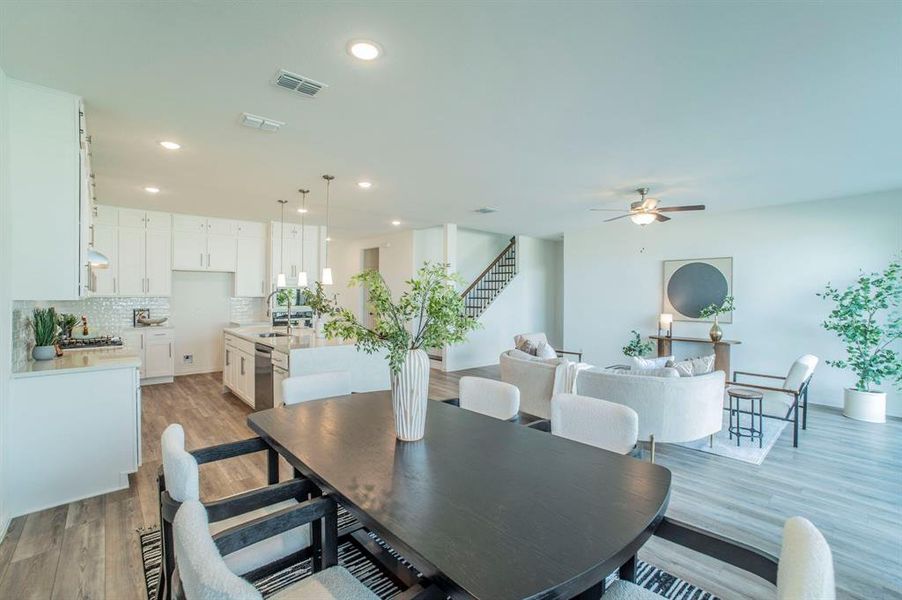 Dining space featuring light wood-style flooring, stairs, recessed lighting, and ceiling fan Dining space featuring light wood-style flooring, stairs, recessed lighting, and ceiling fan