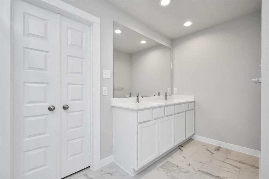 Indulge in a spa-like retreat within the confines of this primary bathroom. Sample photo of completed home with similar floor plan. As-built interior colors and selections may vary.