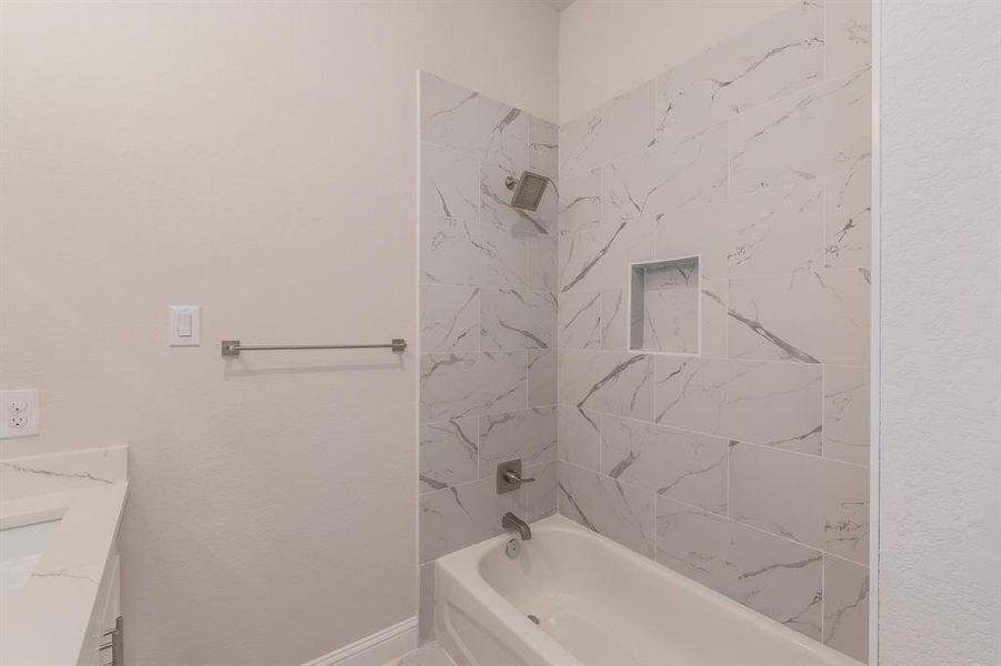 Bathroom with vanity and tiled shower / bath