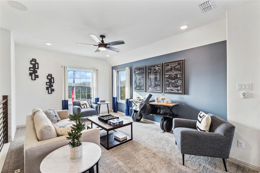 Living room featuring vaulted ceiling and ceiling fan