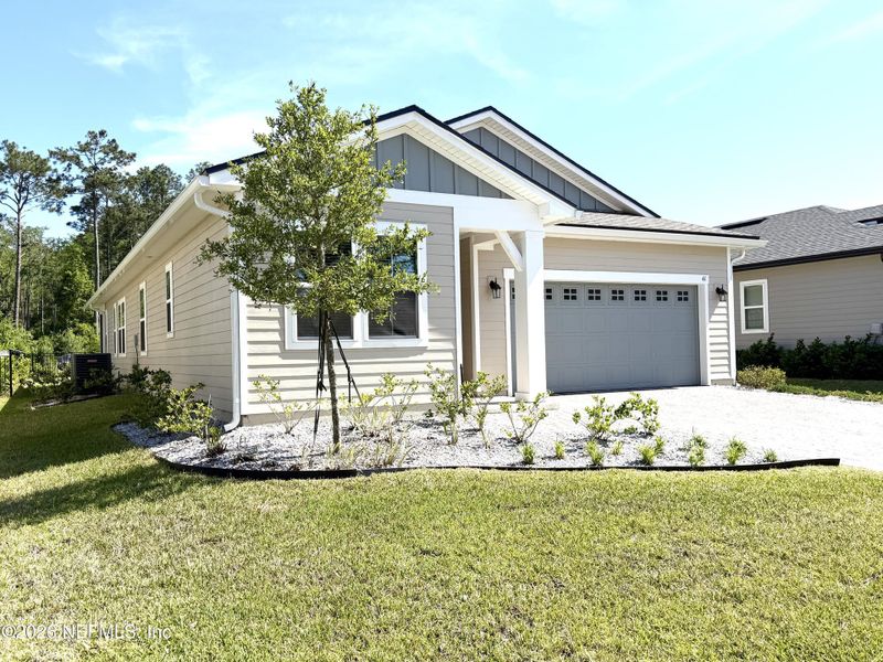Front exterior of a new home in Seasons at TrailMark, St. Augustine, FL, highlighting curb appeal (Image 31).