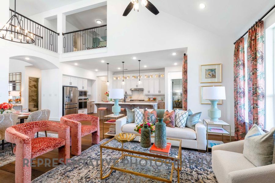 Living area featuring recessed lighting, a high ceiling, arched walkways, a ceiling fan, and wood finished floors Living area featuring recessed lighting, a high ceiling, arched walkways, a ceiling fan, and wood finished floors