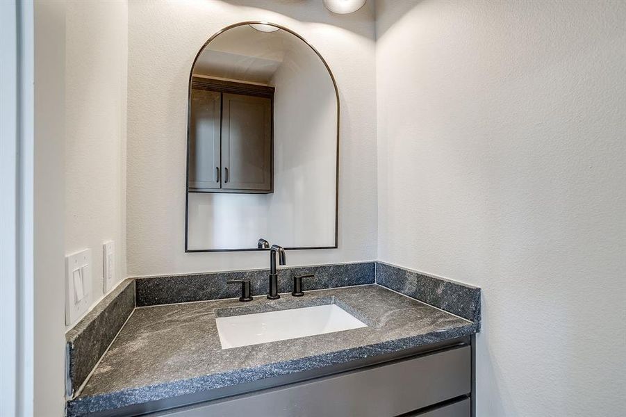 Sleek lighting and stone accents define this modern Fort Worth bathroom. Sleek lighting and stone accents define this modern Fort Worth bathroom.