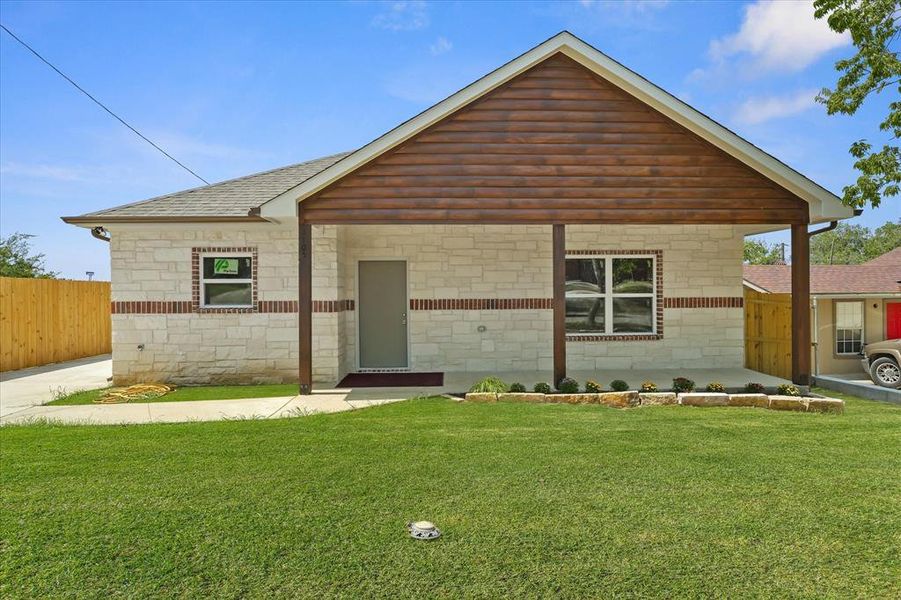 View of front of house featuring a shingled roof and stone siding View of front of house featuring a shingled roof and stone siding