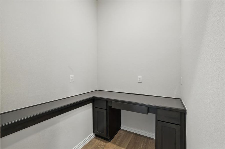 Unfurnished office with light wood-style flooring and baseboards