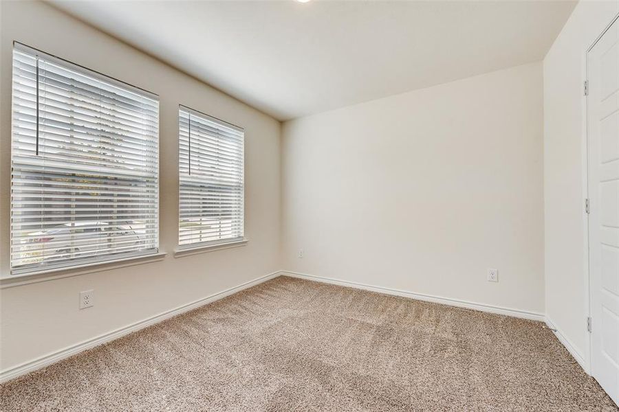 Kitchen featuring backsplash, appliances with stainless steel finishes, light stone countertops, dark brown cabinetry, and a center island with sink Kitchen featuring backsplash, appliances with stainless steel finishes, light stone countertops, dark brown cabinetry, and a center island with sink