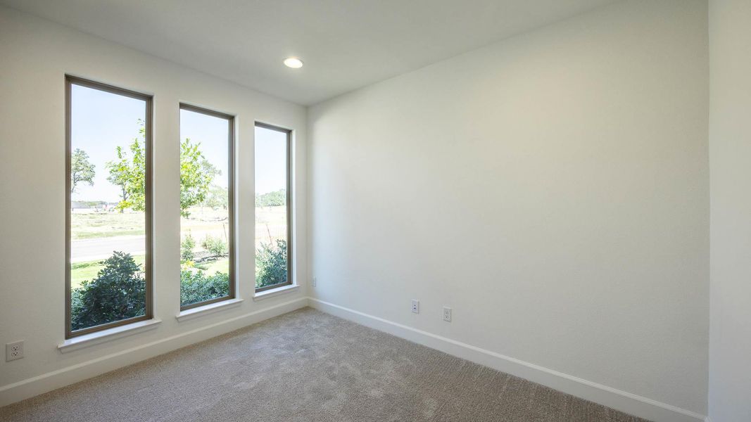 Empty room with carpet flooring and recessed lighting