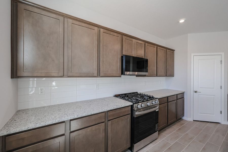 A kitchen with wooden cabinets.