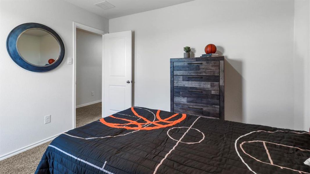 Carpeted bedroom with baseboards