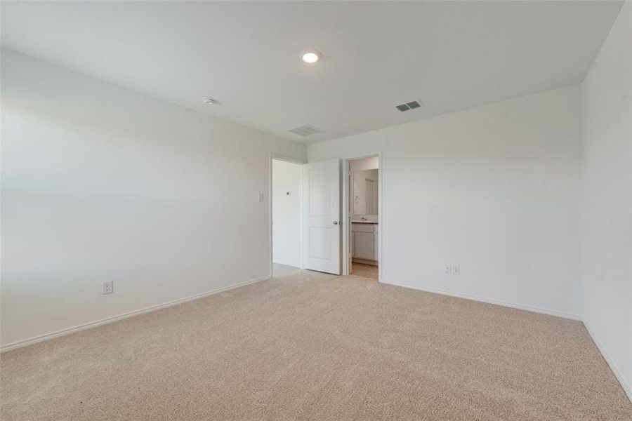 Empty room featuring light colored carpet