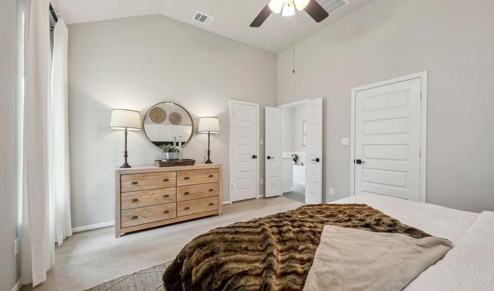 Serene owner's suite with matte black hardware