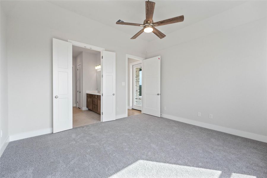 Additional view from primary bedroom looking towards the double door entrance to primary bathroom.