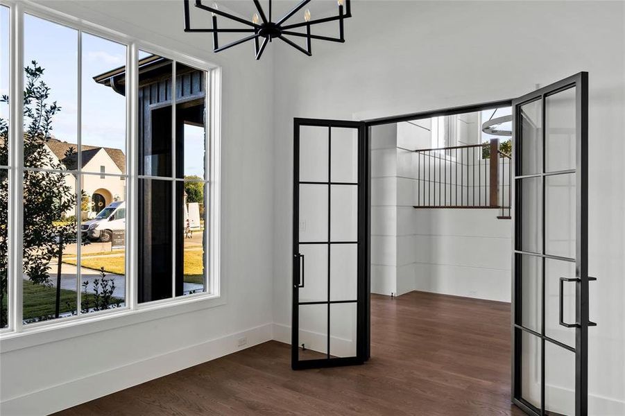 Unfurnished dining area with dark wood finished floors, plenty of natural light, and a chandelier Unfurnished dining area with dark wood finished floors, plenty of natural light, and a chandelier