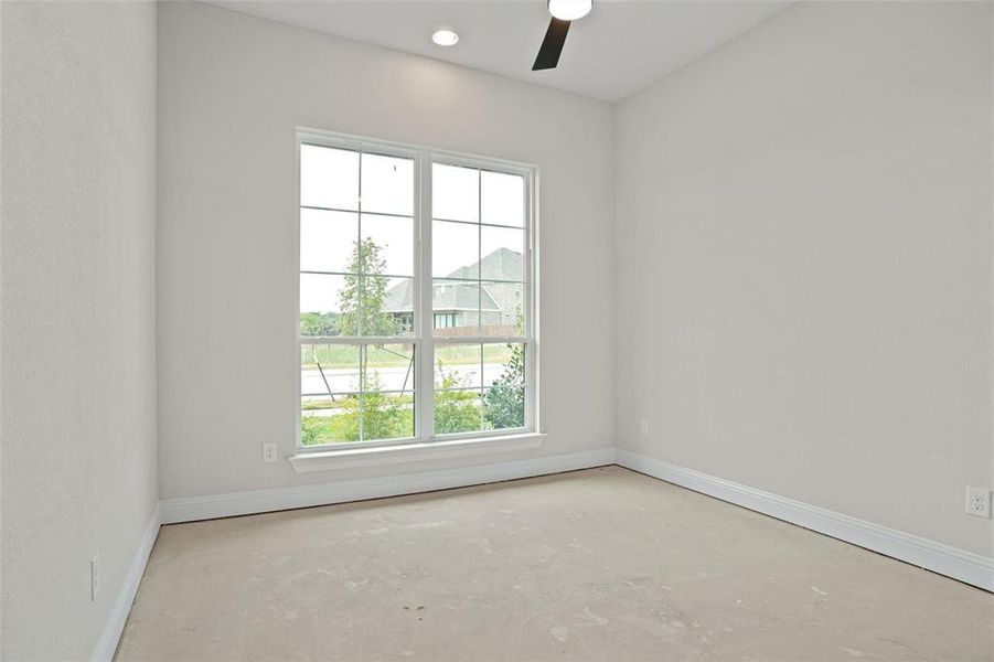 Unfurnished room featuring concrete flooring and ceiling fan