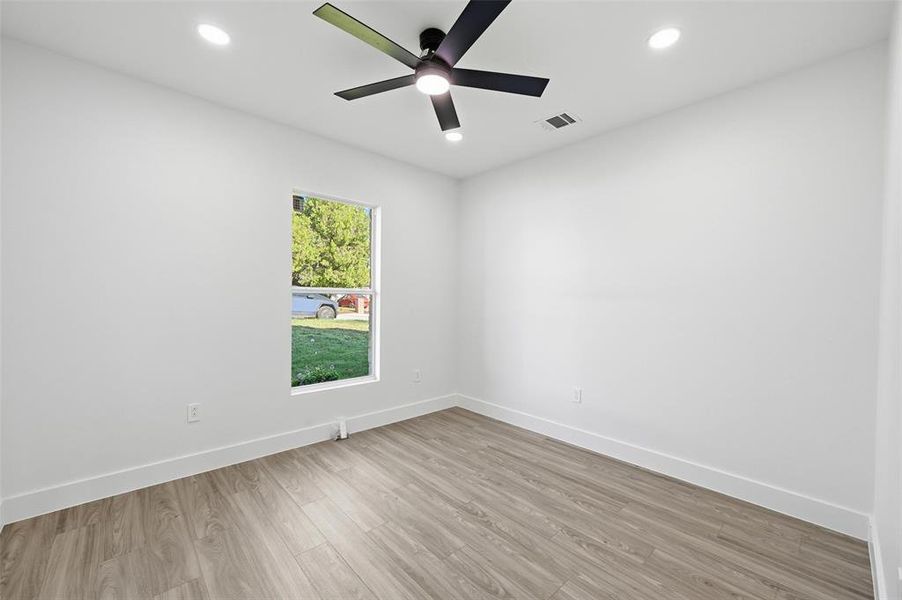 Empty room with wood finished floors, recessed lighting, and ceiling fan Empty room with wood finished floors, recessed lighting, and ceiling fan