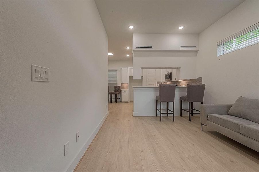 The living room is 11x14 and has transom windows with 2" faux blinds, recessed lighting and 10' ceiling.