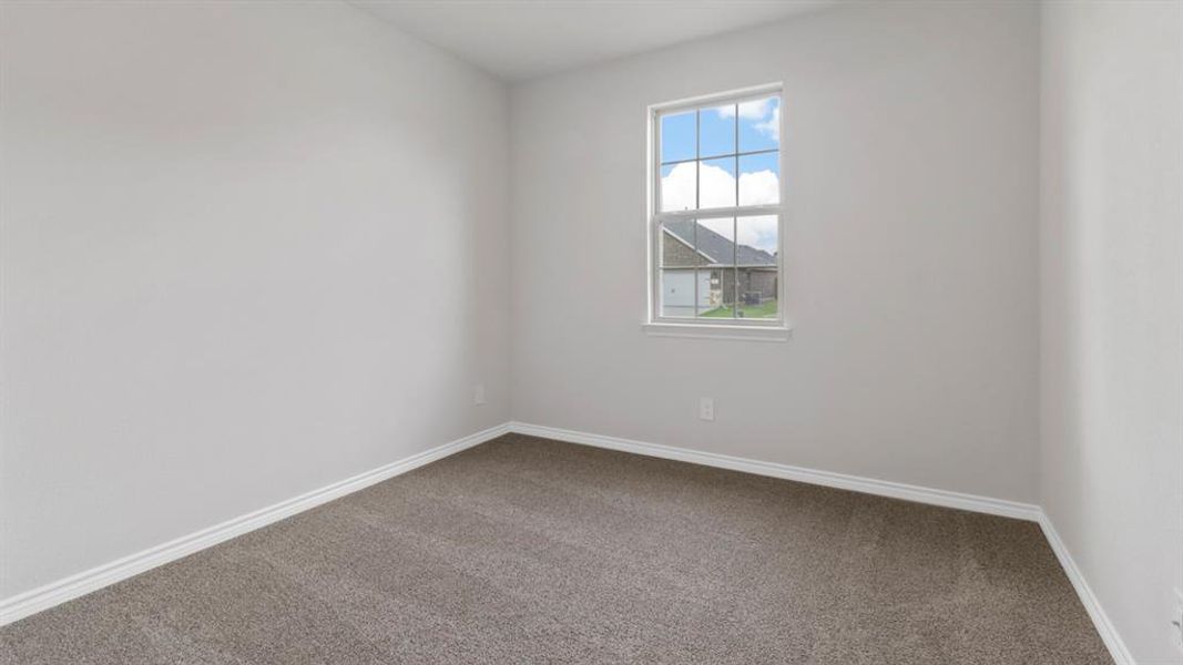 Carpeted empty room with baseboards