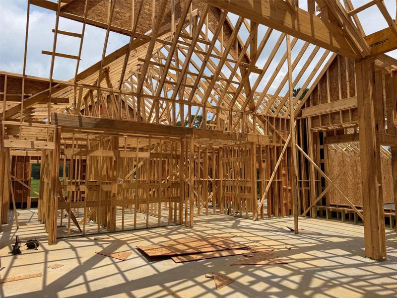 New construction framing showcasing open-concept potential and vaulted ceilings