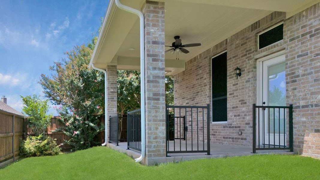 Relax on the covered back patio with ceiling fan overlooking the backyard!