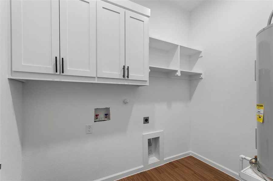 Laundry room with dark wood-style floors, hookup for a washing machine, hookup for an electric dryer, cabinet space, and water heater