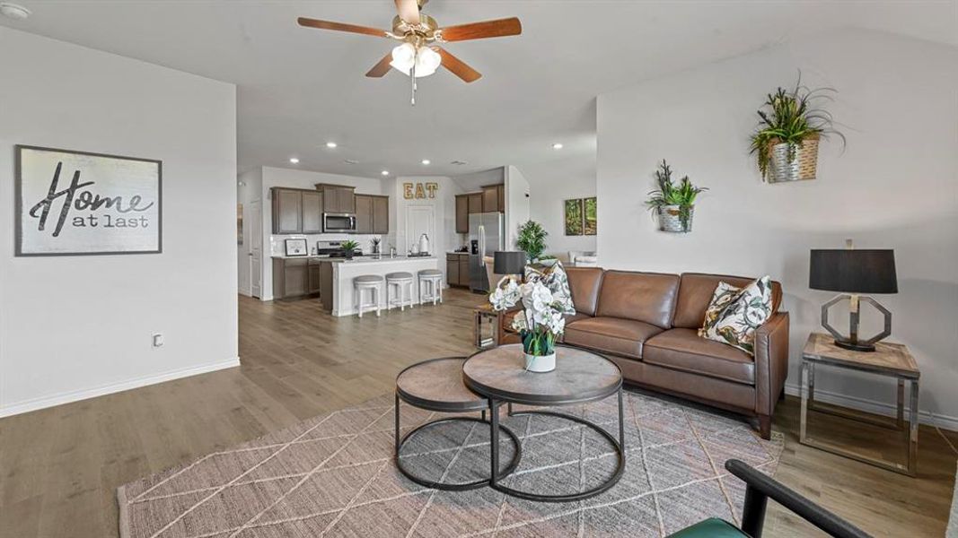 Living area with light wood finished floors, recessed lighting, and a ceiling fan