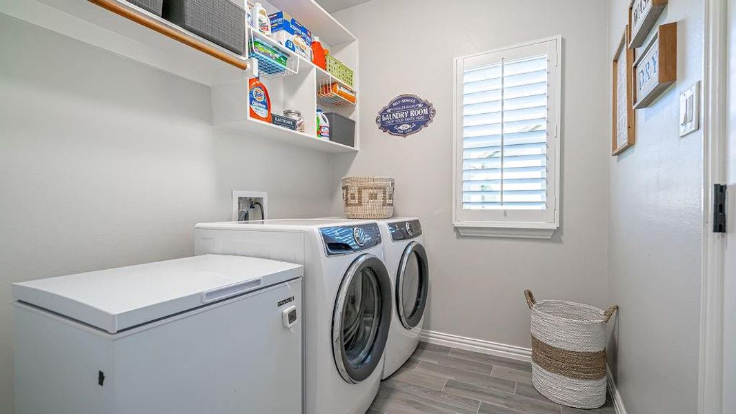 Laundry area featuring independent washer and dryer and hardwood / wood-style flooring